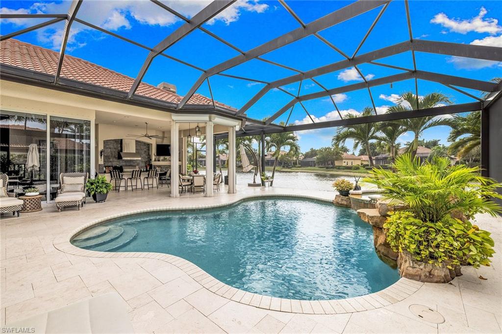 7837 Classics Drive Naples, FL 34113 - Photo 43 of 50 Swimming pool with a sunroom, glass enclosure, and a patio