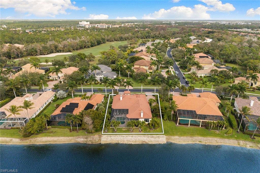 7837 Classics Drive Naples, FL 34113 - Photo 47 of 50 Aerial perspective of suburban area with property boundaries highlighted and a nearby body of water