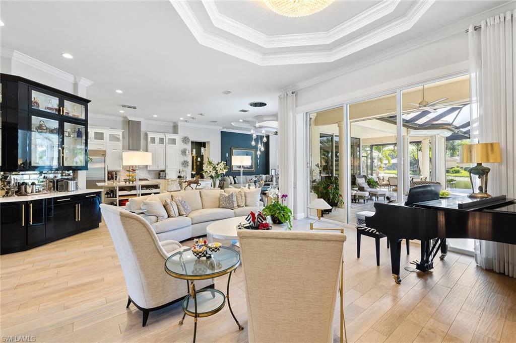 7837 Classics Drive Naples, FL 34113 - Photo 8 of 50 Living area featuring ornamental molding, light wood-style flooring, and recessed lighting