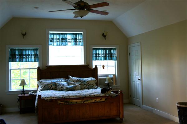 69 Carpenter Road Monson, MA 01057 - Photo 8 of 16 a bed sitting in a bedroom next to a window