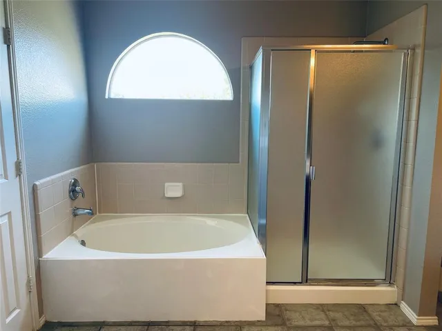 a white bath tub sitting next to a shower