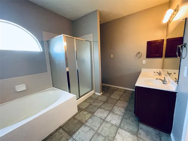 a bathroom with a bathtub sink and mirror