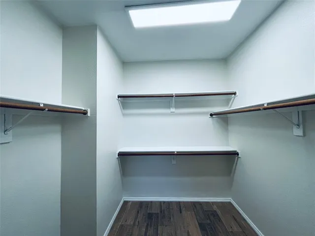 a view of walk in closet with empty racks