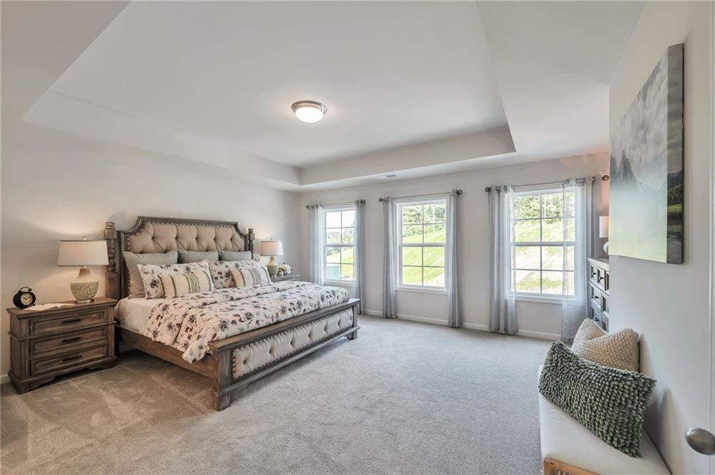 156 Millers Lane Calhoun, GA 30701 - Photo 15 of 26 a spacious bedroom with a bed a couch and a window