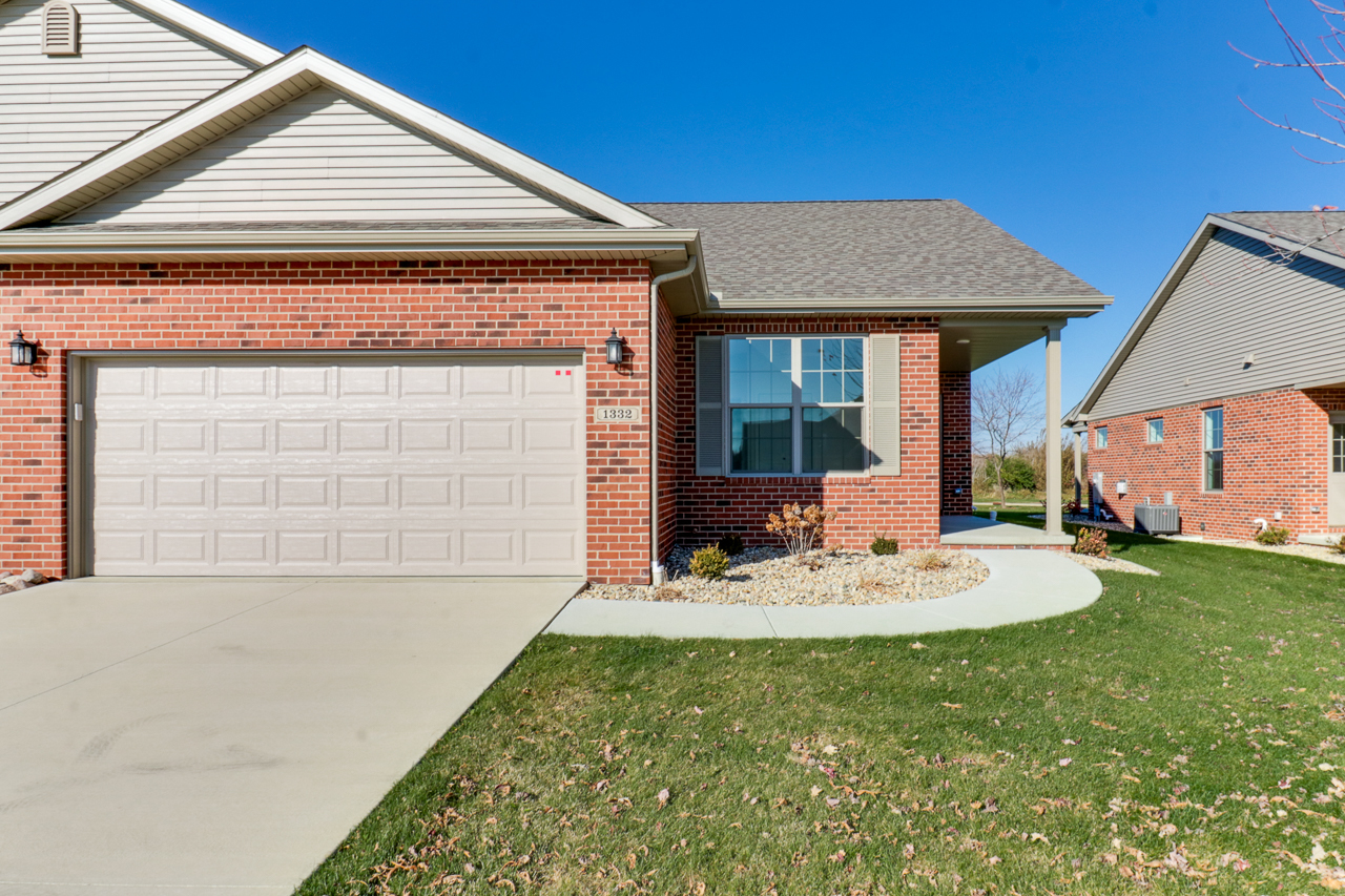 1332 Monterey Pine Drive Normal, IL 61761 - Photo 2 of 33 a front view of a house with a garden and patio