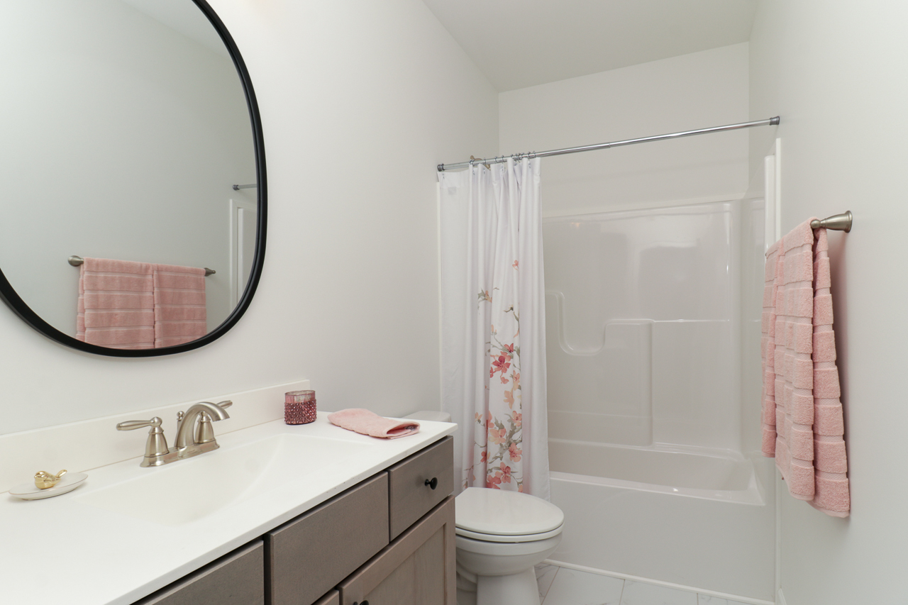 1332 Monterey Pine Drive Normal, IL 61761 - Photo 27 of 33 a bathroom with a sink a toilet and a mirror