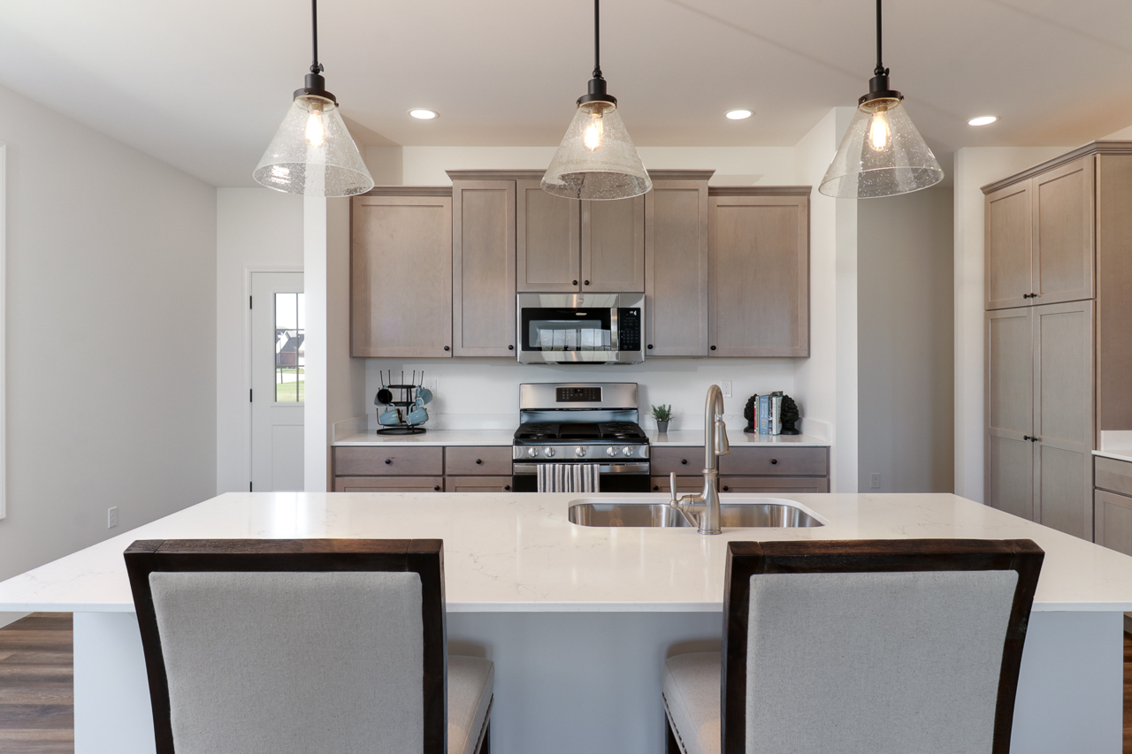 1332 Monterey Pine Drive Normal, IL 61761 - Photo 6 of 33 a kitchen with kitchen island a sink stainless steel appliances and white cabinets