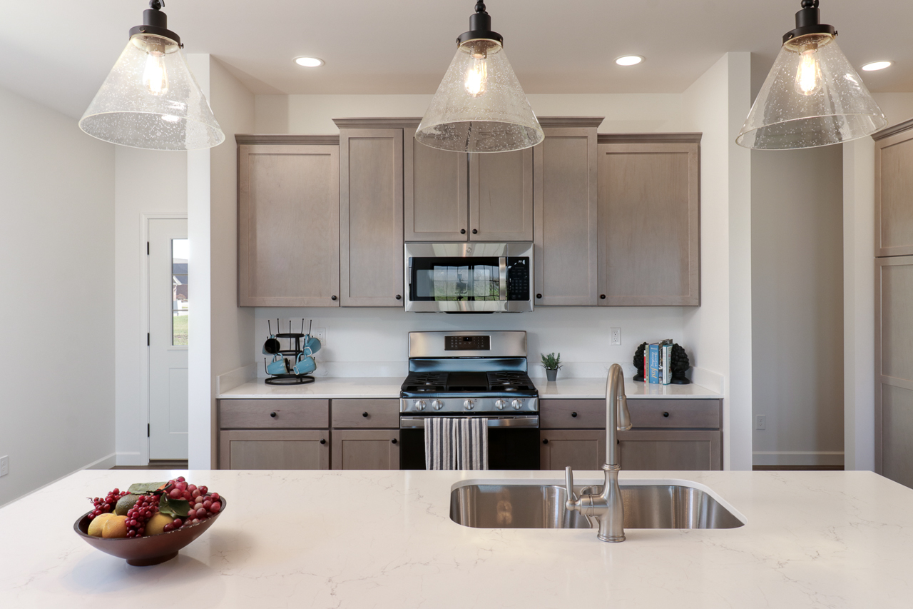 1332 Monterey Pine Drive Normal, IL 61761 - Photo 10 of 33 a kitchen with stainless steel appliances kitchen island granite countertop a refrigerator and a sink