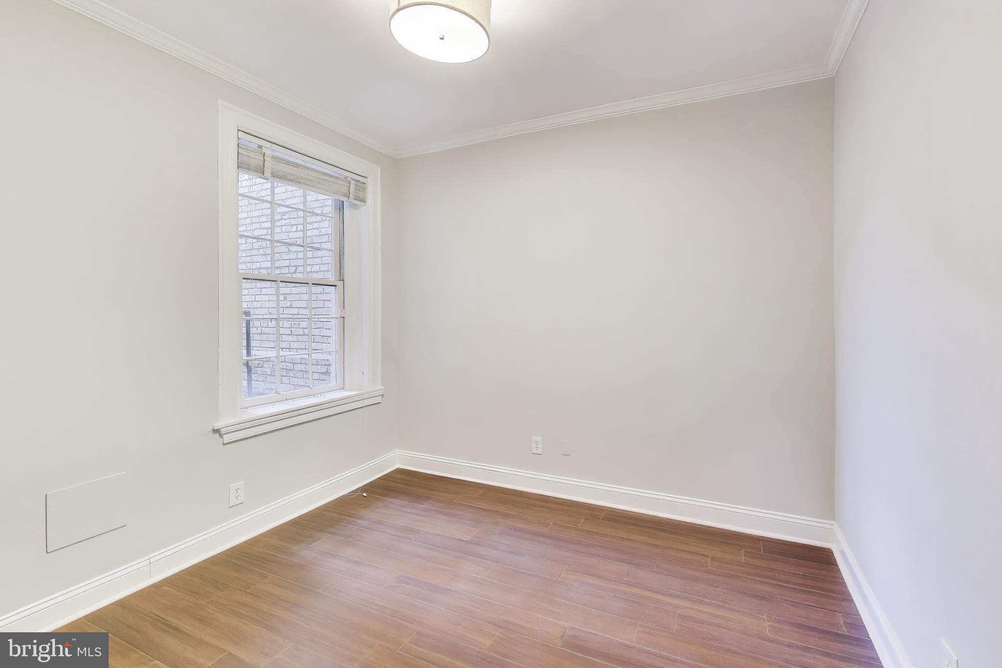 1724 21st Street Northwest, Unit 3 Washington, DC 20009 - Photo 11 of 17 an empty room with wooden floor and windows