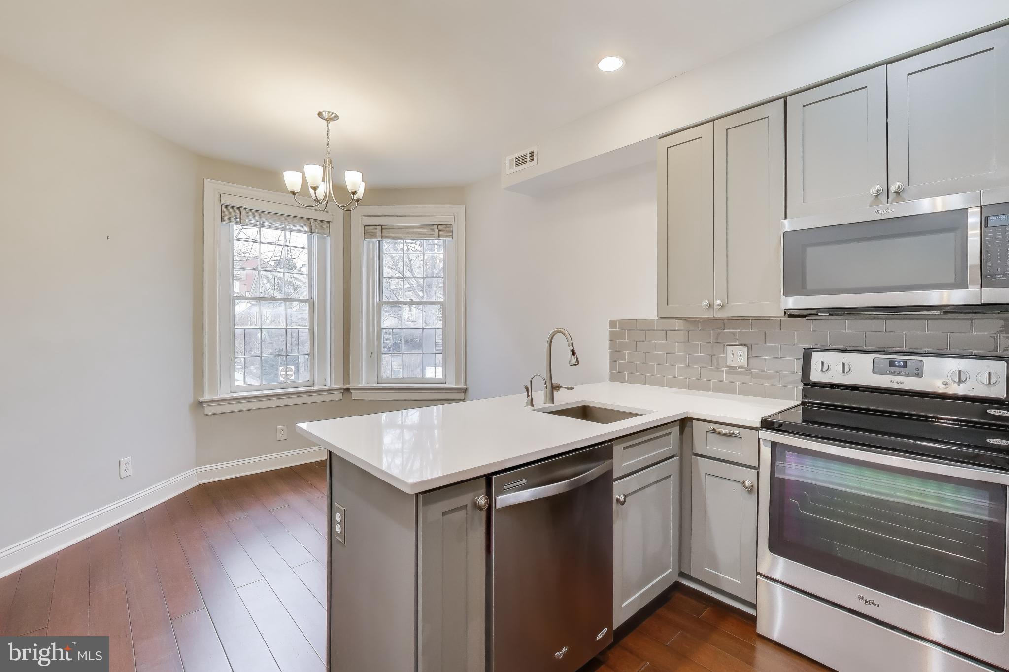 1724 21st Street Northwest, Unit 3 Washington, DC 20009 - Photo 2 of 17 a kitchen with a sink stove and microwave