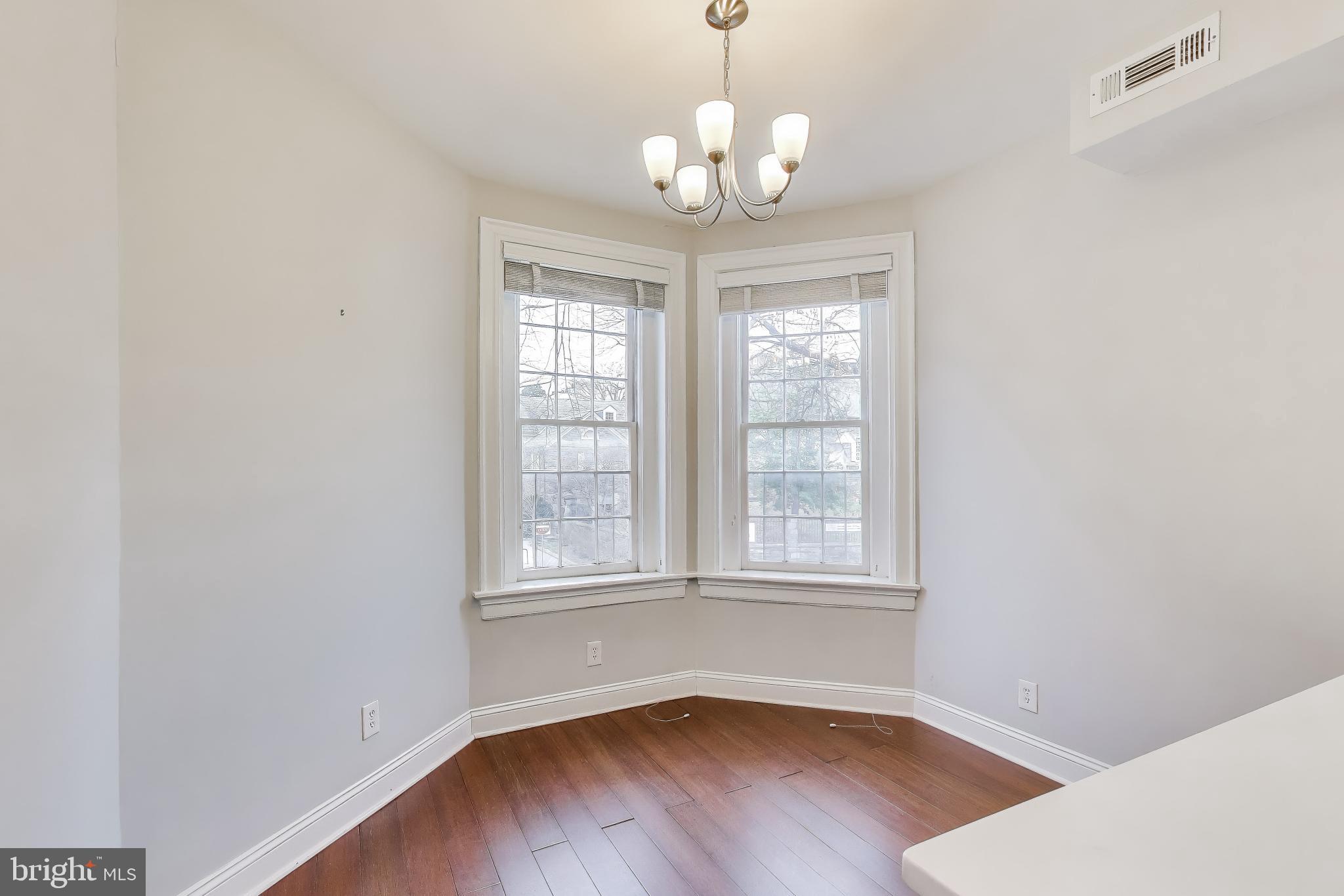 1724 21st Street Northwest, Unit 3 Washington, DC 20009 - Photo 9 of 17 an empty room with wooden floor and windows