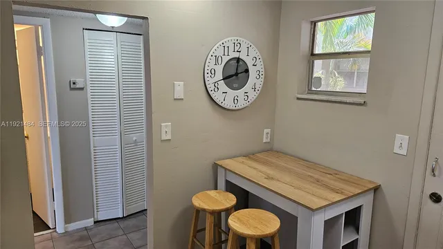 a view of a bathroom with a table and a chair