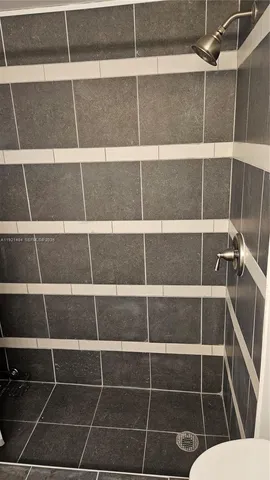 a view of a room with a door and a window