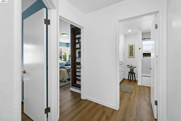 a view of a hallway with wooden floor windows and livingroom