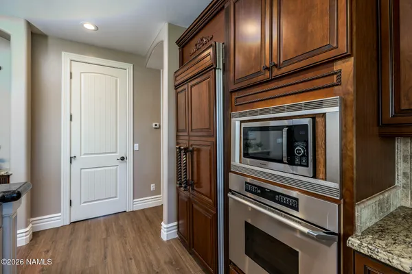 a bedroom with a bed and a television on the dresser