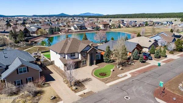 an aerial view of a house with swimming pool and ocean view