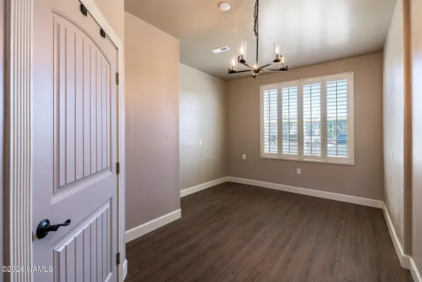 a very nice looking room with a large window and a chandelier
