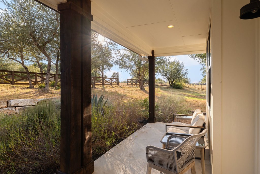 32045 Mirela Ann Road Dripping Springs, TX 78620 - Photo 33 of 36 Thick timber columns frame peaceful country views from this sheltered concrete porch.