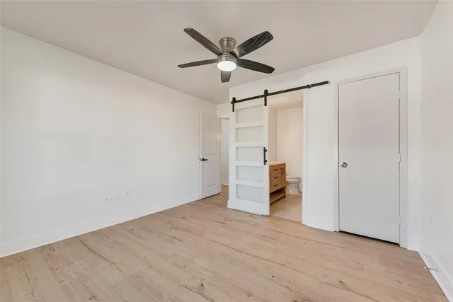 a view of empty room with ceiling fan