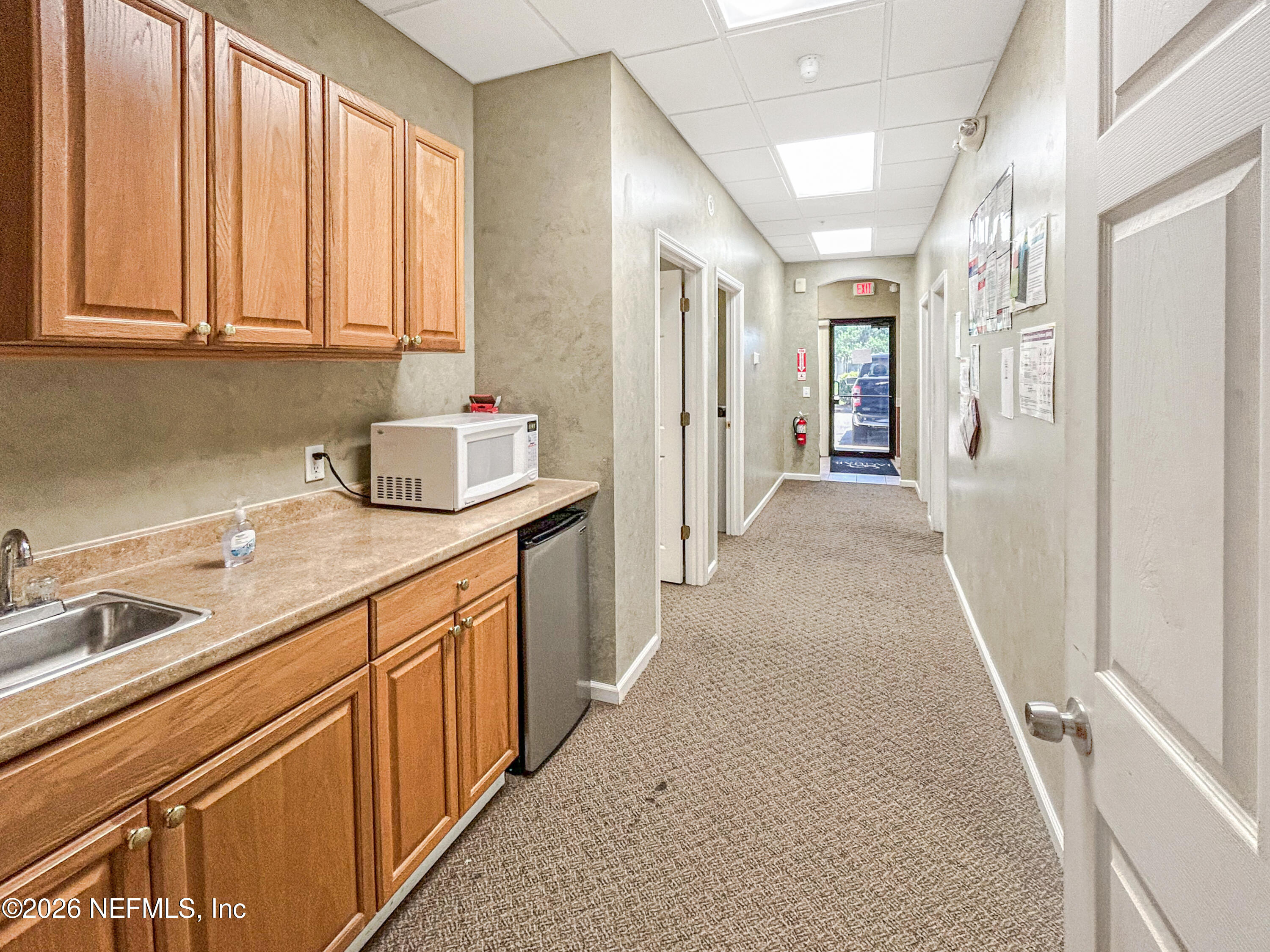 1635 Farm Way, Unit 402 Middleburg, FL 32068 - Photo 9 of 20 a hallway with sink and large window