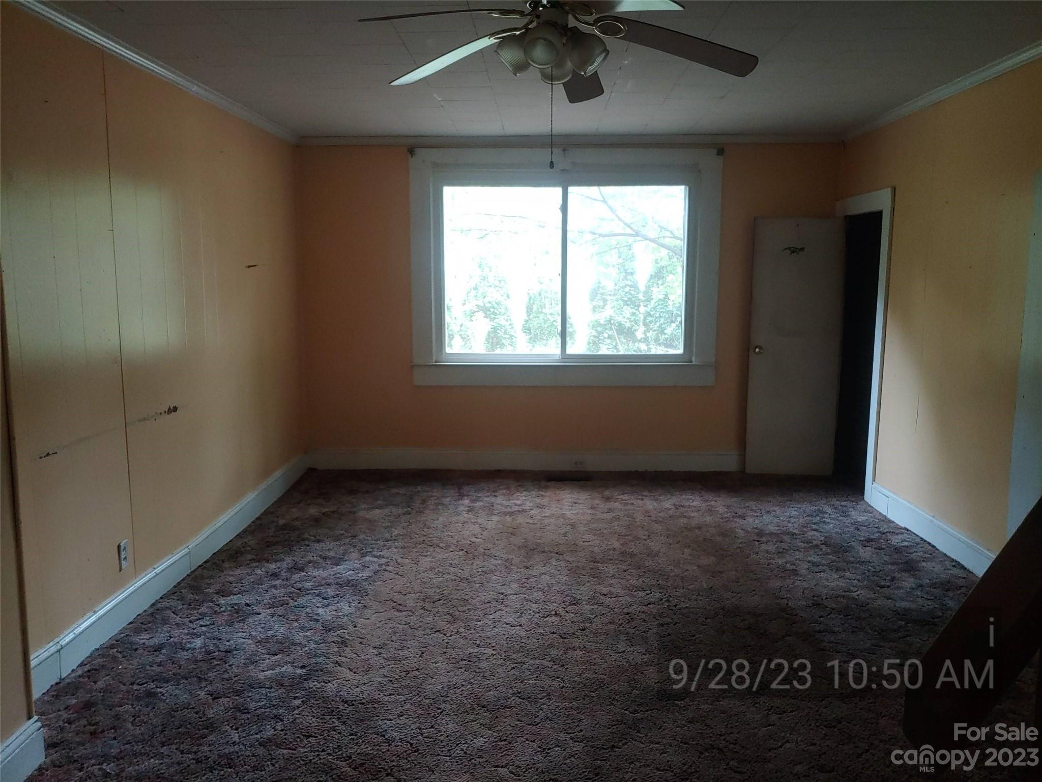 403 Vance Avenue Salisbury, NC 28144 - Photo 5 of 14 an empty room with a ceiling fan and window