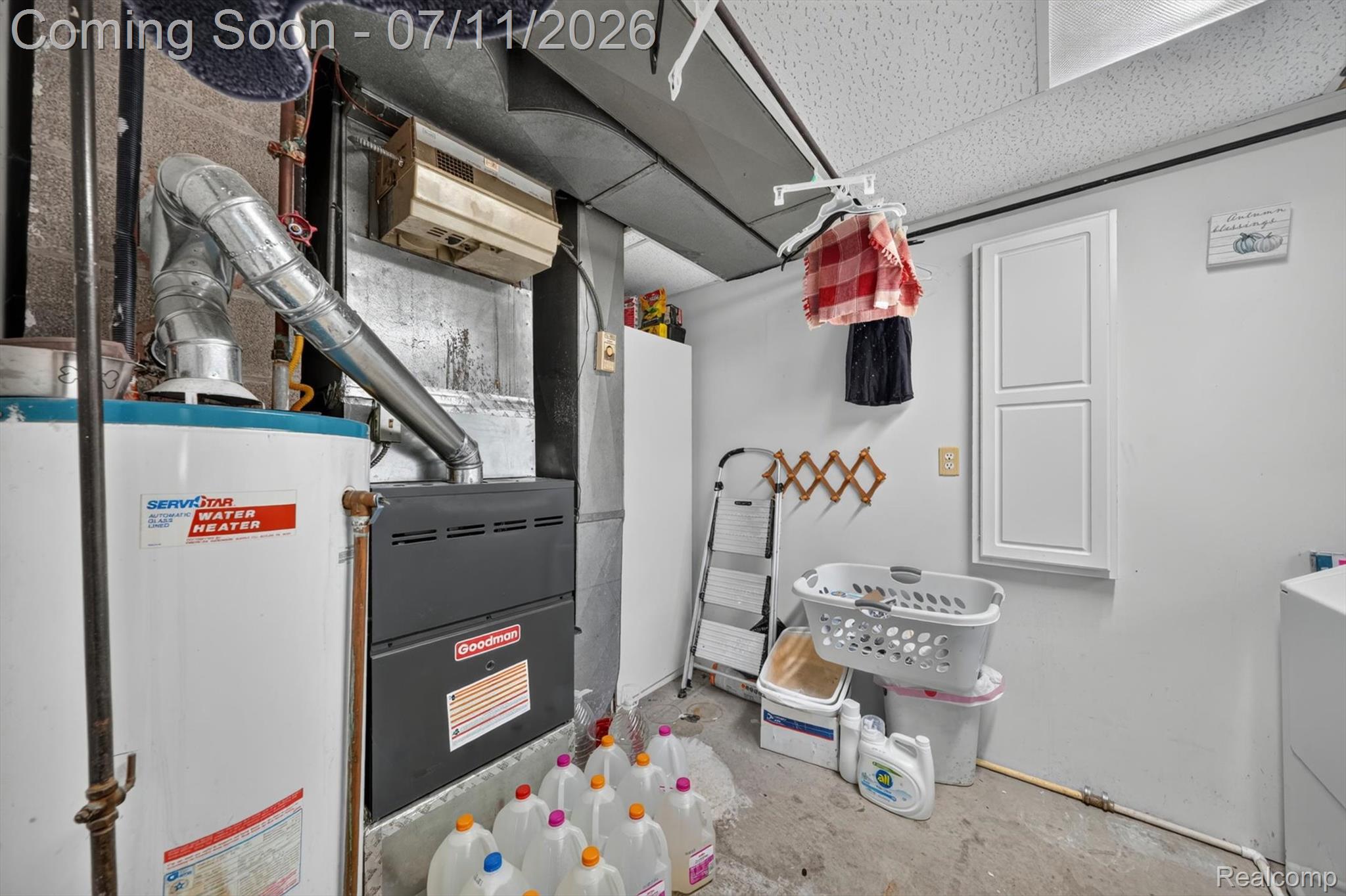 4430 North Center Road Flint, MI 48506 - Photo 40 of 49 Utility room featuring a water heater, furnace, and drop ceiling