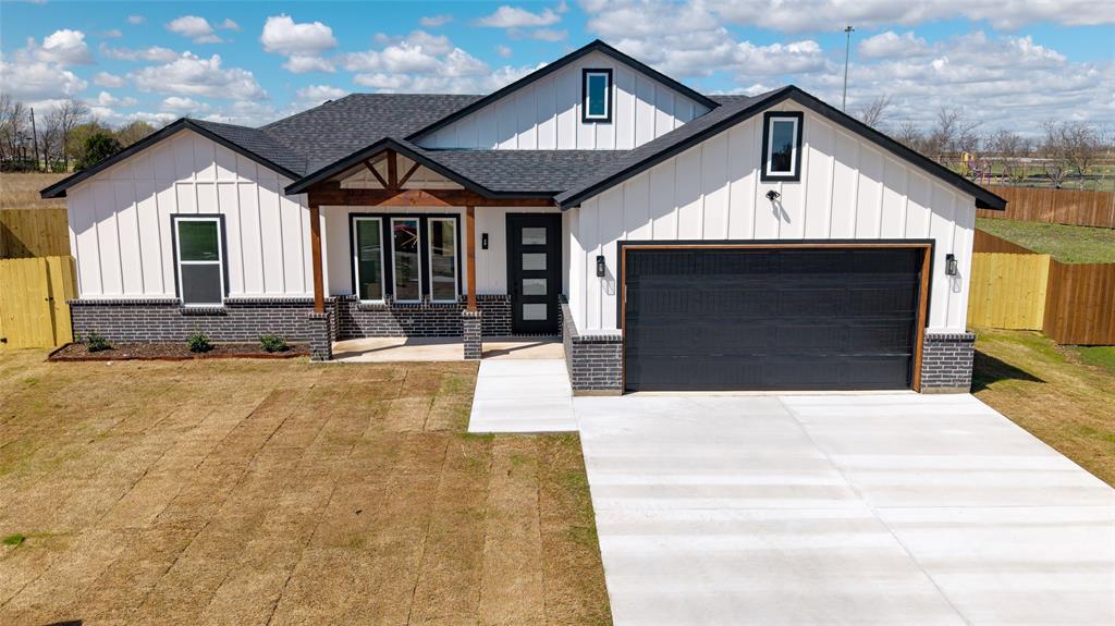 592 Highview Court Godley, TX 76044 - Photo 1 of 21 Modern farmhouse featuring board and batten siding, covered porch, roof with shingles, a garage, and concrete driveway