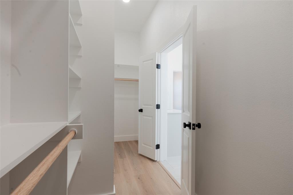592 Highview Court Godley, TX 76044 - Photo 11 of 21 Walk in closet featuring light wood-type flooring