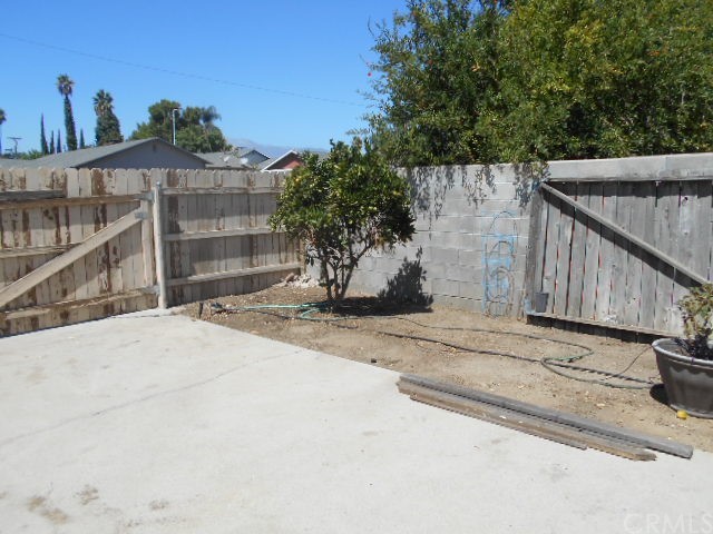 811 Riverside Rialto, CA 92376 - Photo 6 of 25 a view of a entrance gate of the house and trees