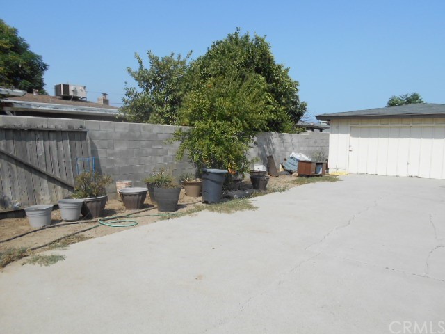 811 Riverside Rialto, CA 92376 - Photo 7 of 25 a view of a patio with table and chairs with wooden fence and plants