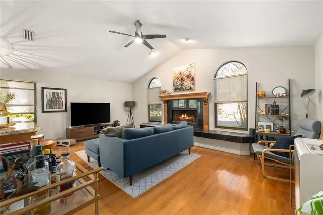 a living room with furniture a fireplace and a flat screen tv