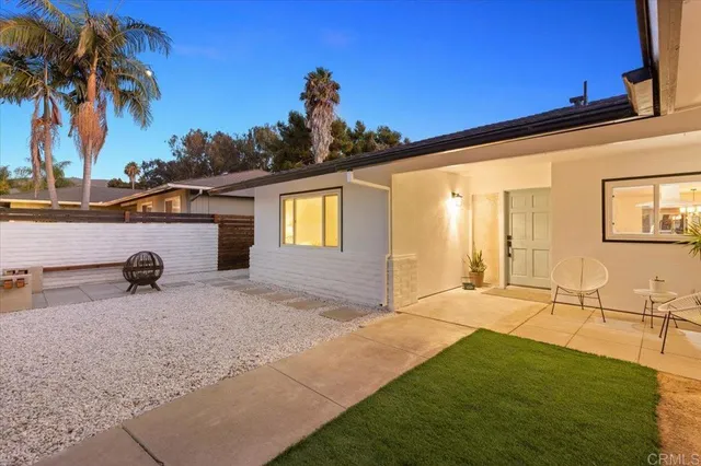 a view of an house with backyard space and palm tree