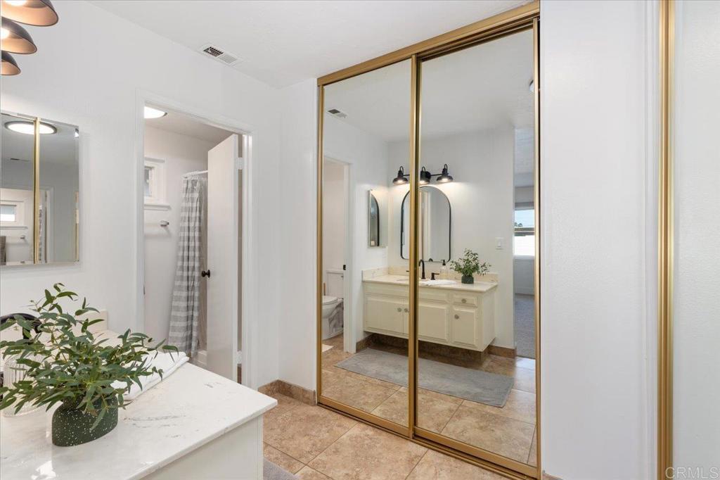 1267 Discovery Street San Marcos, CA 92078 - Photo 14 of 75 a bathroom with a tub shower sink and mirror