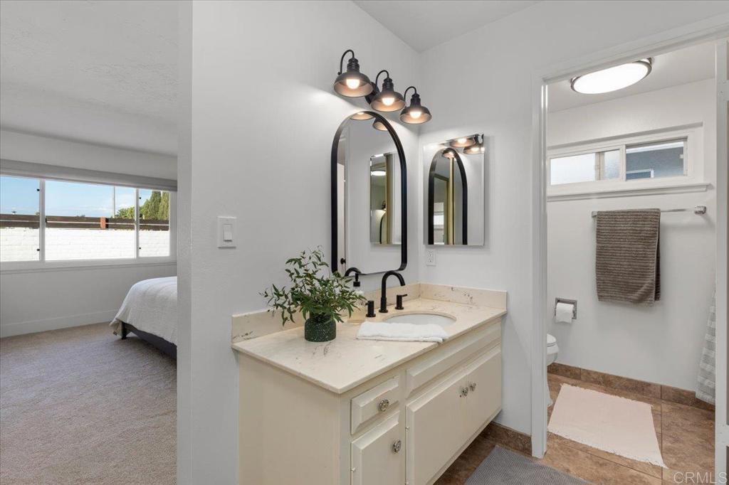 1267 Discovery Street San Marcos, CA 92078 - Photo 15 of 75 a bathroom with a double vanity sink mirror and