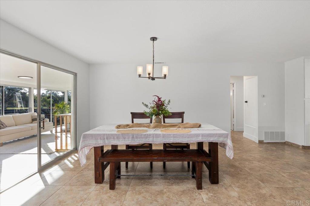 1267 Discovery Street San Marcos, CA 92078 - Photo 19 of 75 a dining room with furniture window and wooden floor