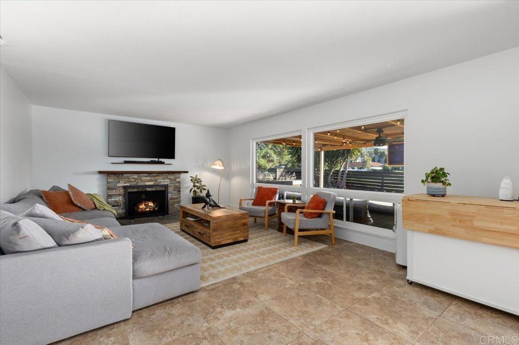 1267 Discovery Street San Marcos, CA 92078 - Photo 20 of 75 a living room with furniture a fireplace and a flat screen tv