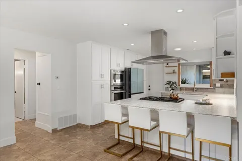 a bedroom with a bed and large windows