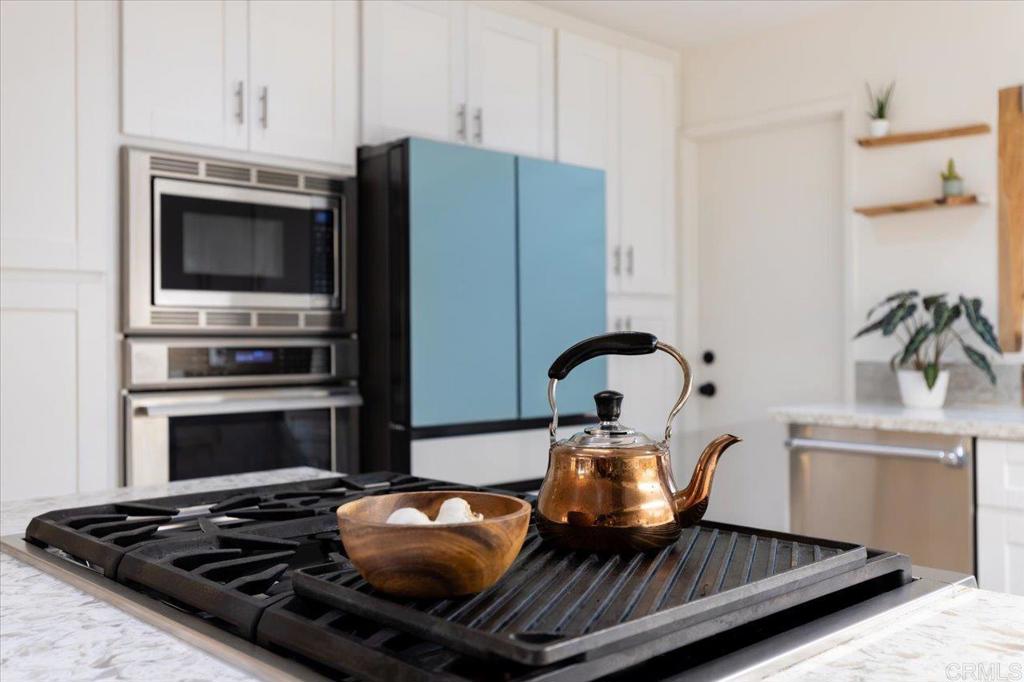 1267 Discovery Street San Marcos, CA 92078 - Photo 25 of 75 a kitchen with a stove and a refrigerator