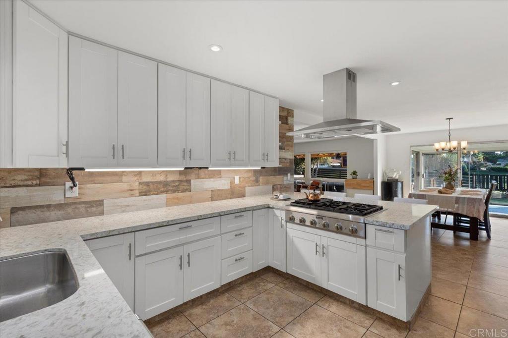 1267 Discovery Street San Marcos, CA 92078 - Photo 28 of 75 a kitchen with a sink dishwasher and white cabinets with wooden floor