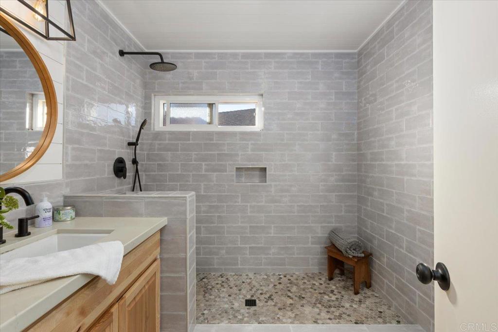 1267 Discovery Street San Marcos, CA 92078 - Photo 32 of 75 a bathroom with a sink a toilet and mirror