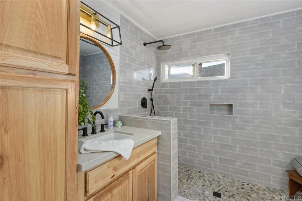 1267 Discovery Street San Marcos, CA 92078 - Photo 33 of 75 a bathroom with a sink vanity granite and a mirror