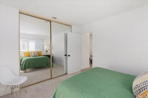 a balcony with furniture and a potted plant