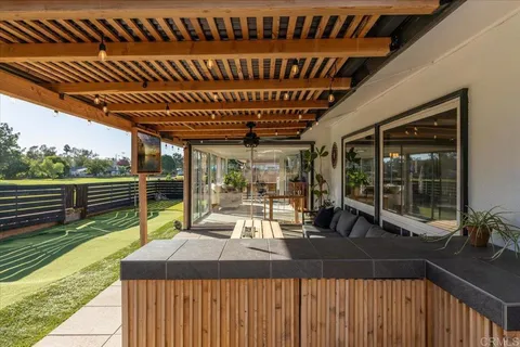 a view of a terrace with lawn chairs