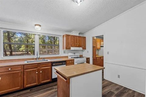 a kitchen with a stove a sink and a refrigerator