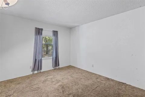 an empty room with windows and mountain view