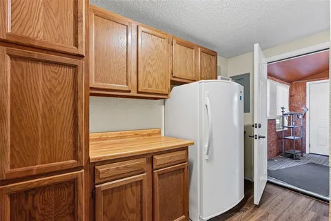 a white refrigerator freezer and a wooden cabinets
