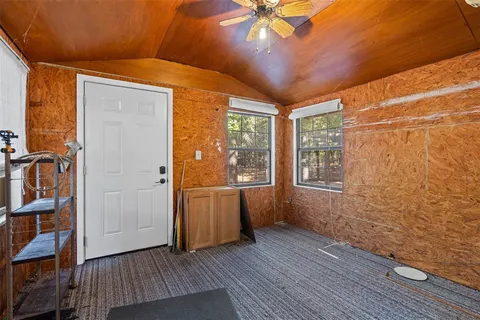 a view of a room with wooden floor and door