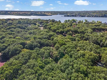 an aerial view of a houses with a yard