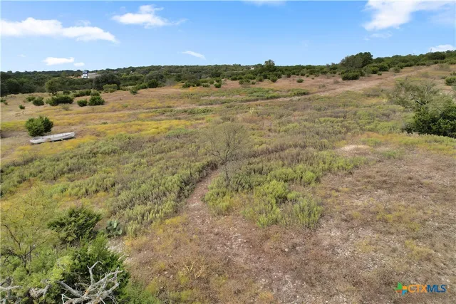 a view of a house with wooden deck and a backyard