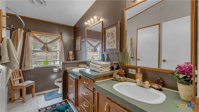 a bedroom with bed and a chandelier